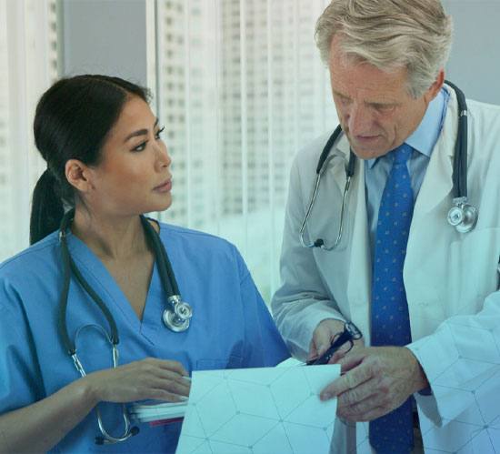 Male doctor standing next to a female nurse